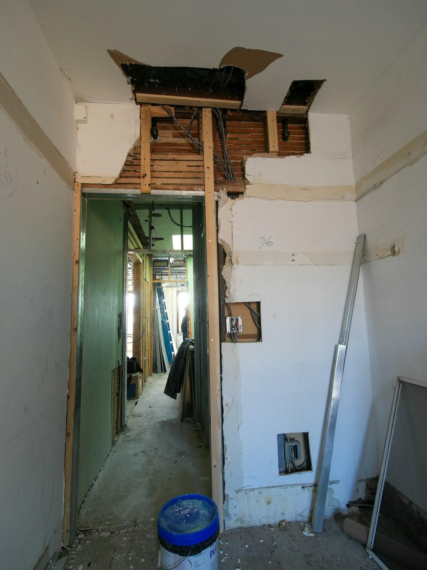 Interior renovation with exposed walls and framing